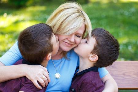 40168479-mother-with-two-sons-in-park-on-bench-boys-hug-mom