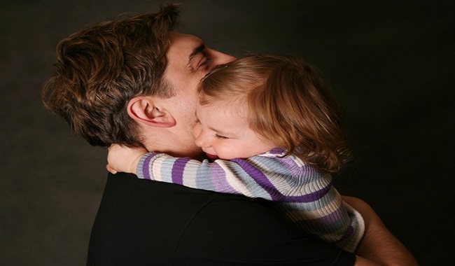 The small daughter embraces the father