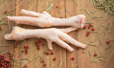 Chicken feet on the wooden background