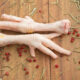 Chicken feet on the wooden background