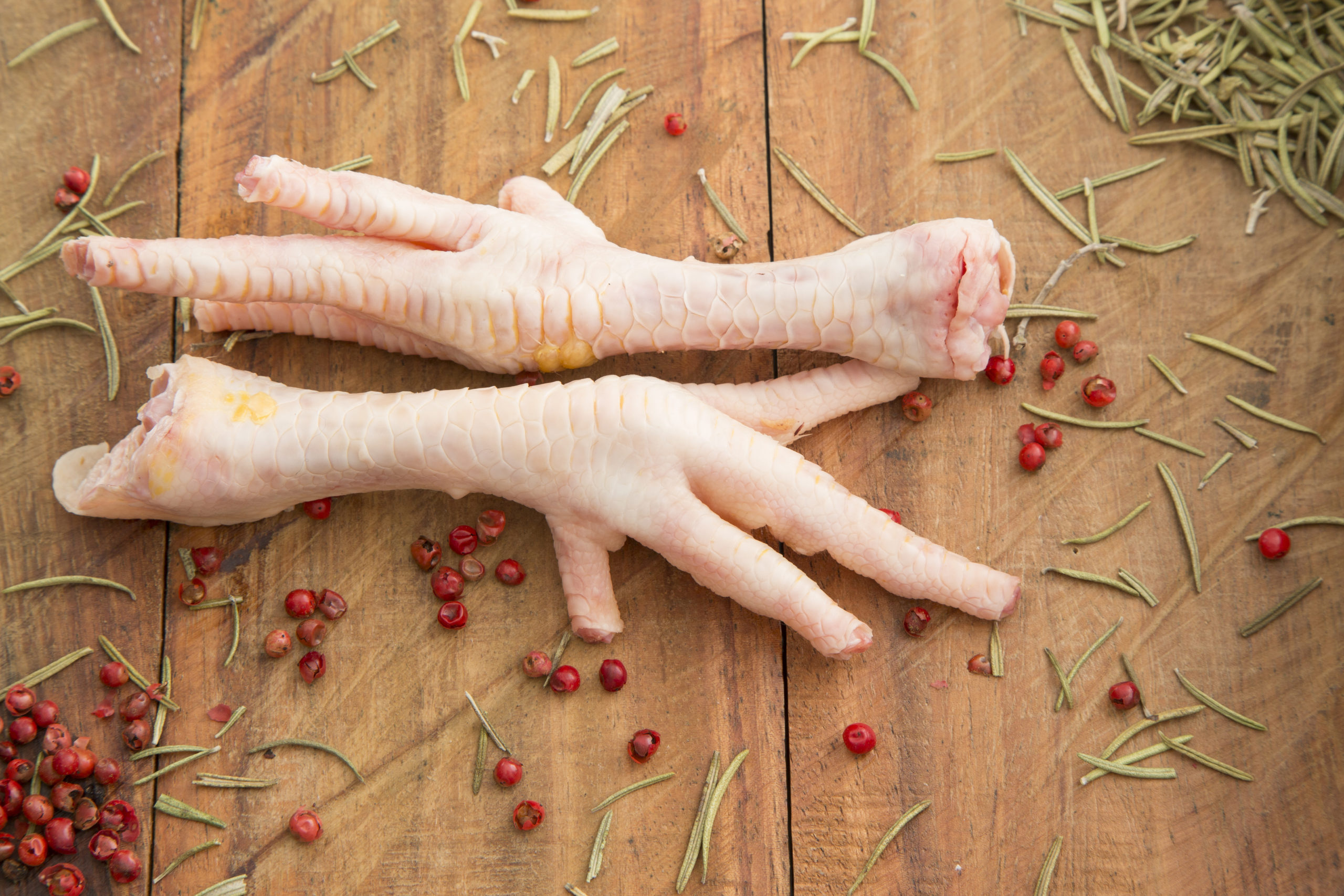 Chicken feet on the wooden background