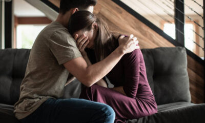 Husband comforting his sick wife at home. Receiving bad news.