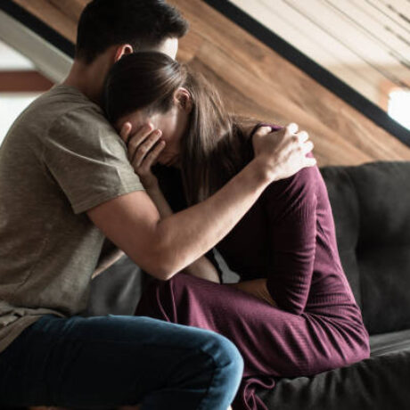 Husband comforting his sick wife at home. Receiving bad news.