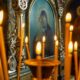 Blurred wax burning candles in an orthodox church on the icon background.