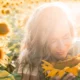 close-up-woman-holding-sunflower-768×511