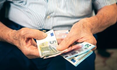 Old man sitting at home counting her money