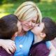 40168479-mother-with-two-sons-in-park-on-bench-boys-hug-mom