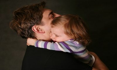 The small daughter embraces the father